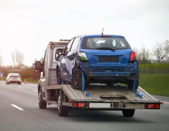 Towing Truck carrying wrecked Car for Emergency Towing